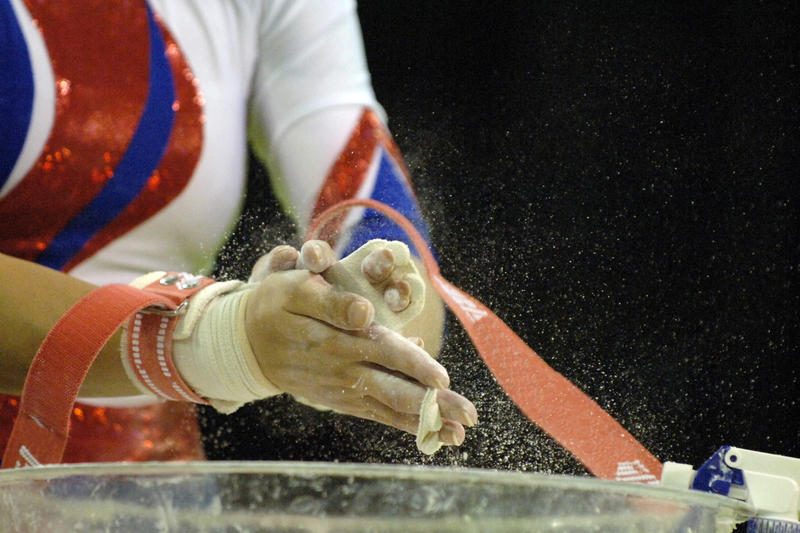 female gymnast chalks up her hands